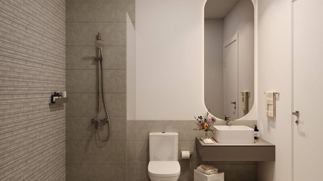 Modern minimalist bathroom with walk-in shower, oval mirror, and sleek neutral-toned design
